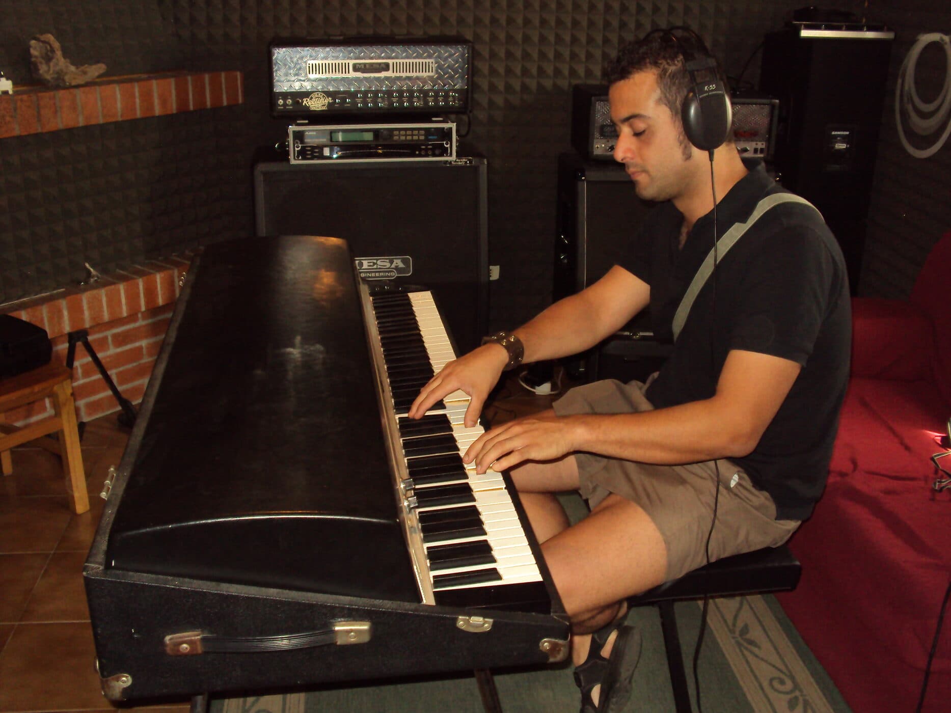 Osman Meyredi recording keyboards in the studio, headphones on