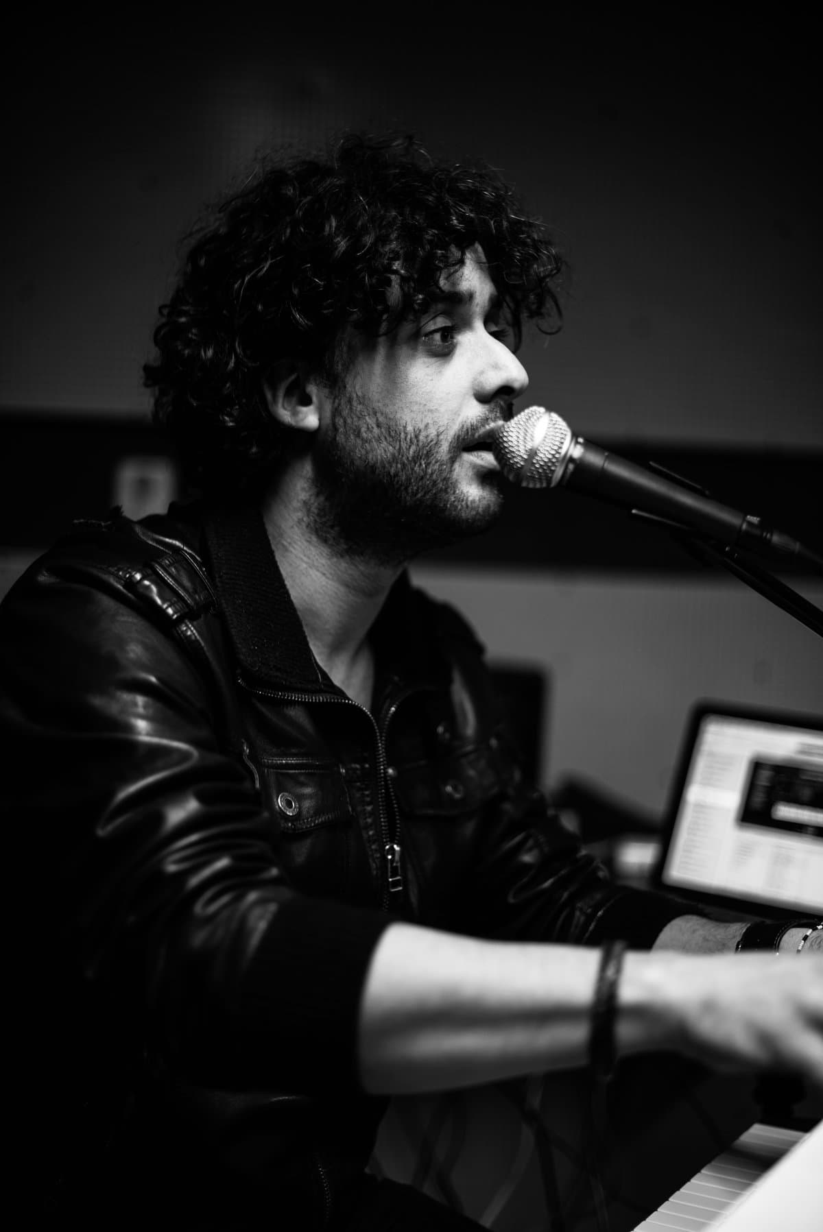 Osman Meyredi singing at the keyboard during rehearsals