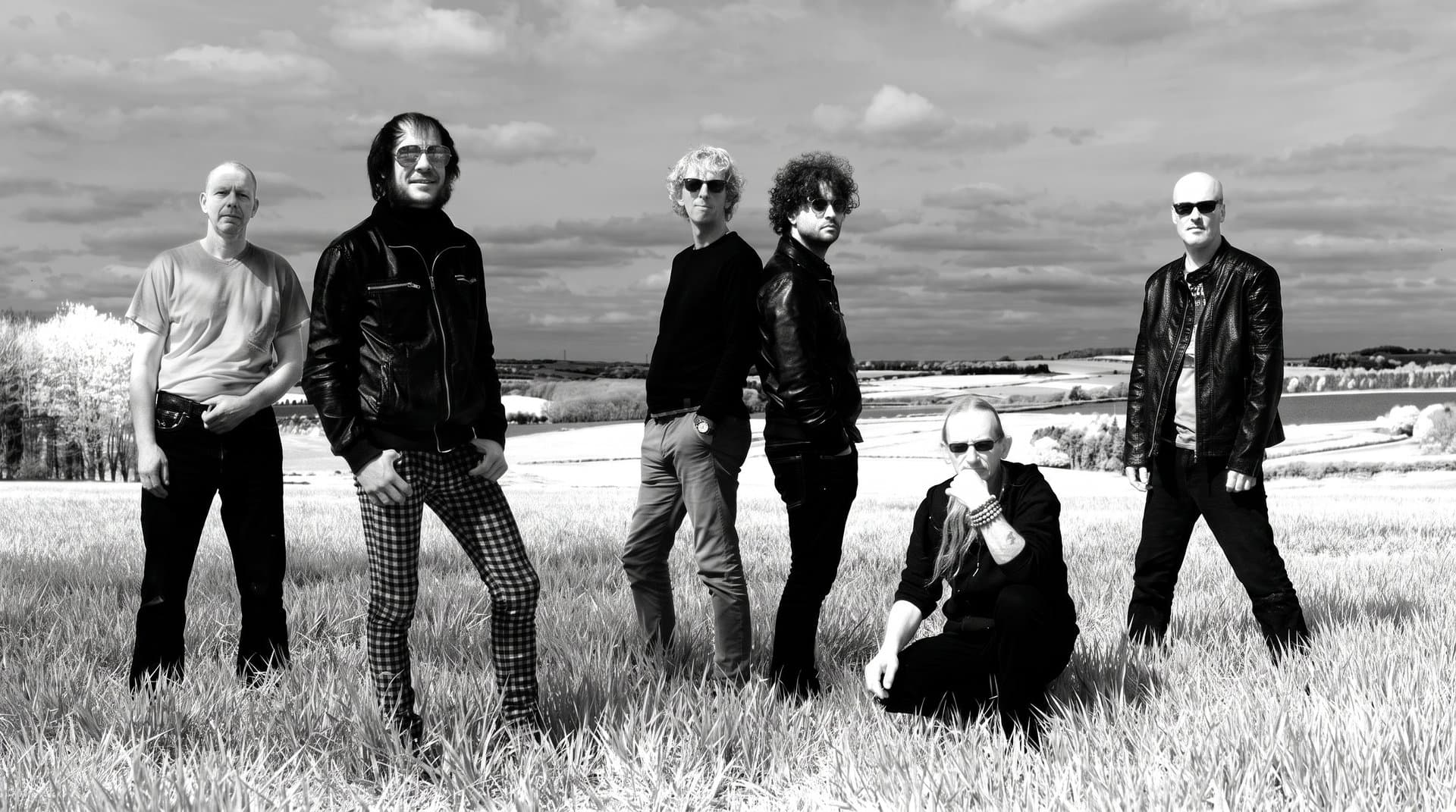 ZAPPATiKA band members standing in a field on the U.K. tour, black and white